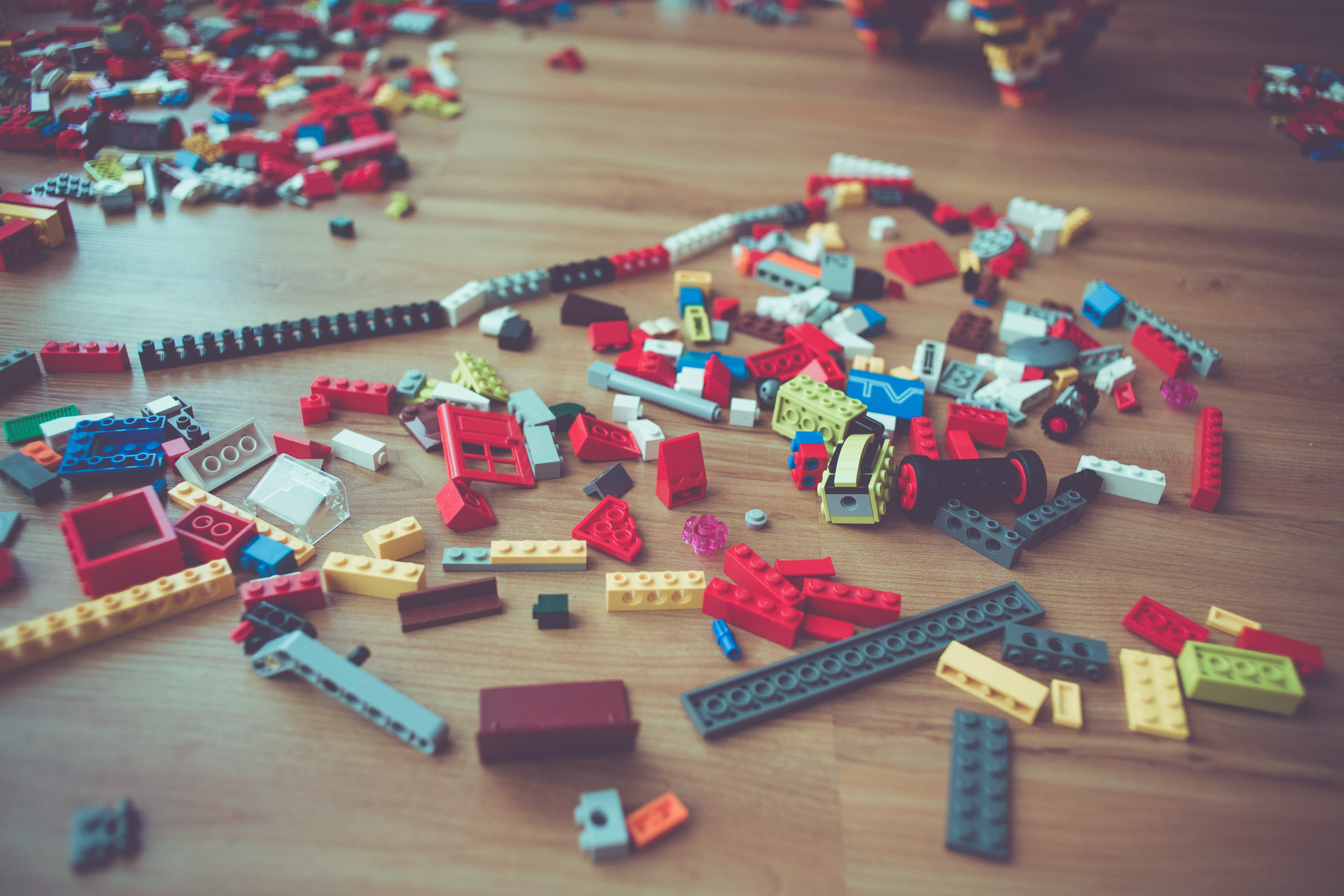 Banner image showing lego pieces pread out on a wooden floor